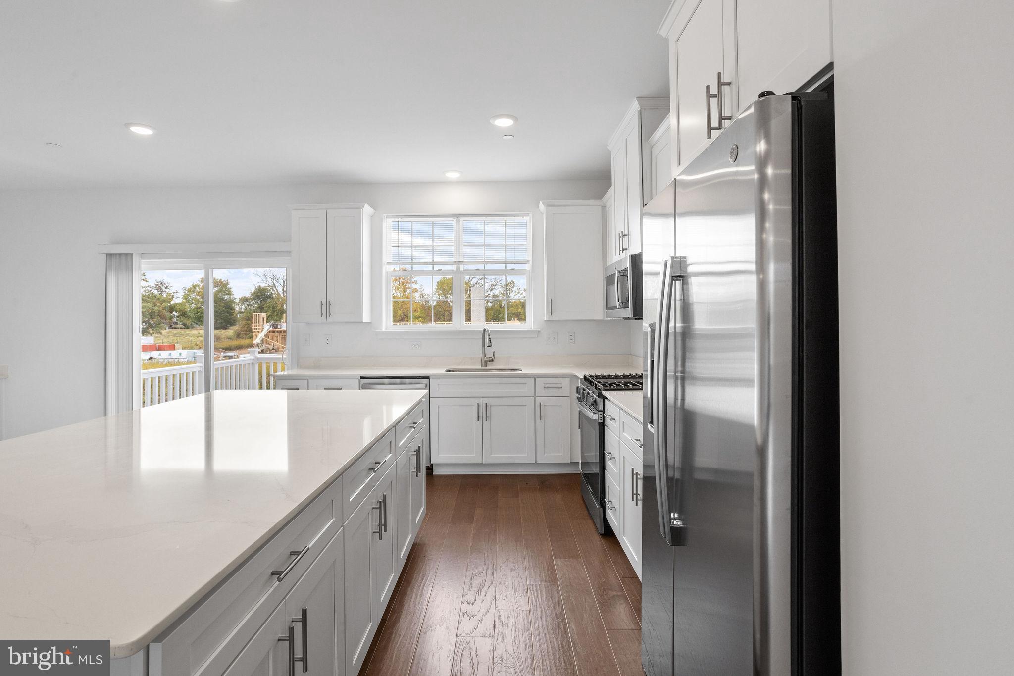 142 ADA Hightower Avenue Pennington, NJ 08534 - Photo 6 of 46 a kitchen with a refrigerator a sink and windows