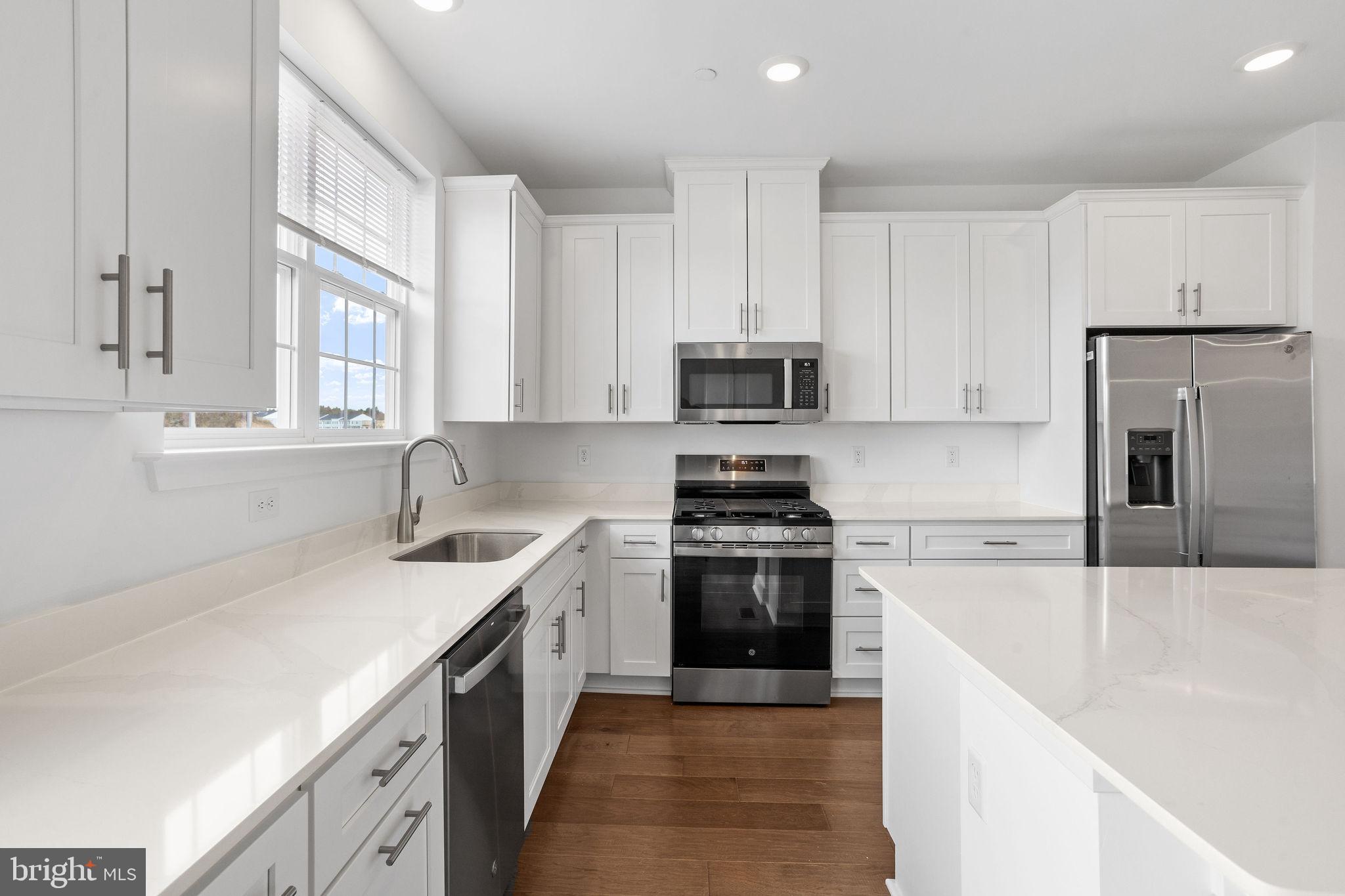 142 ADA Hightower Avenue Pennington, NJ 08534 - Photo 7 of 46 a kitchen with stainless steel appliances granite countertop a sink stove and refrigerator