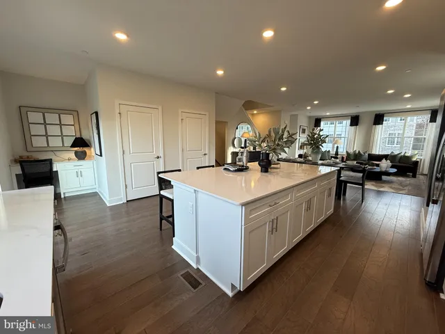 a kitchen with stainless steel appliances a sink a stove top oven a counter space and cabinets