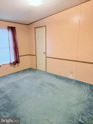 a bathroom with a toilet and a shower curtain