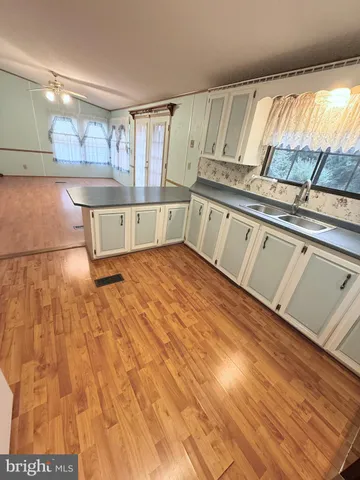 a front view of a house with a garden and yard