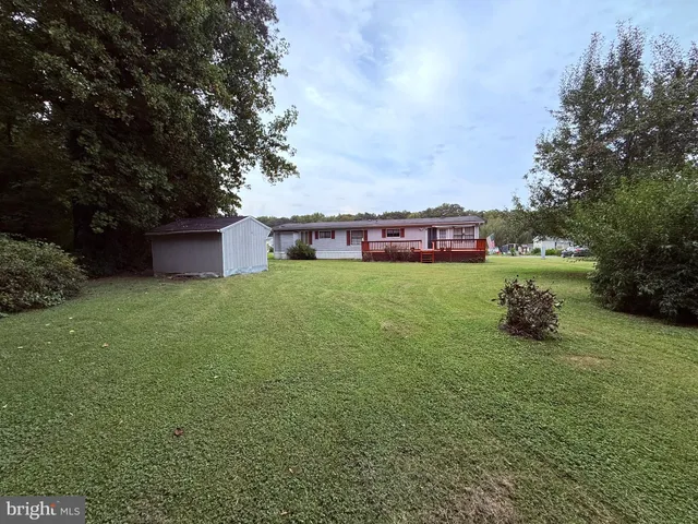 a view of a house with a yard and sitting area