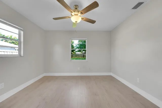 wooden floor in an empty room with a window