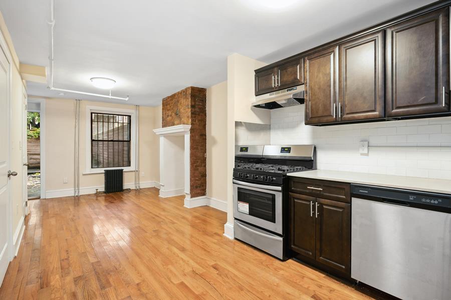 a kitchen with stainless steel appliances granite countertop a stove and a refrigerator