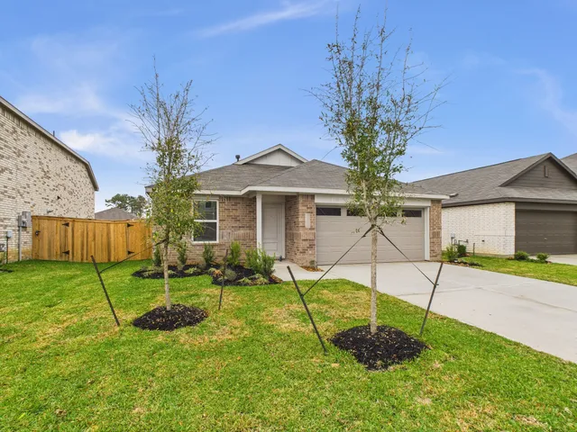 a view of a house with backyard and a patio