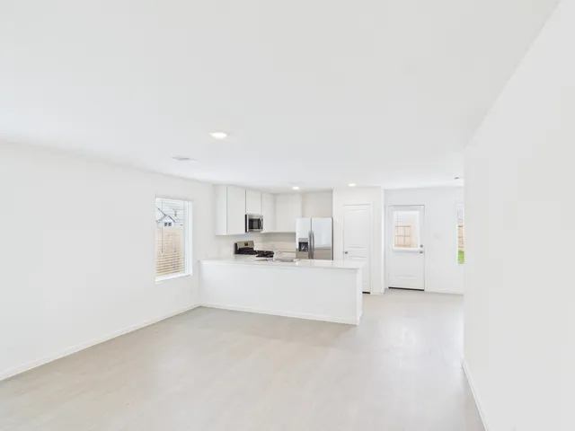 a large white bed in a white room