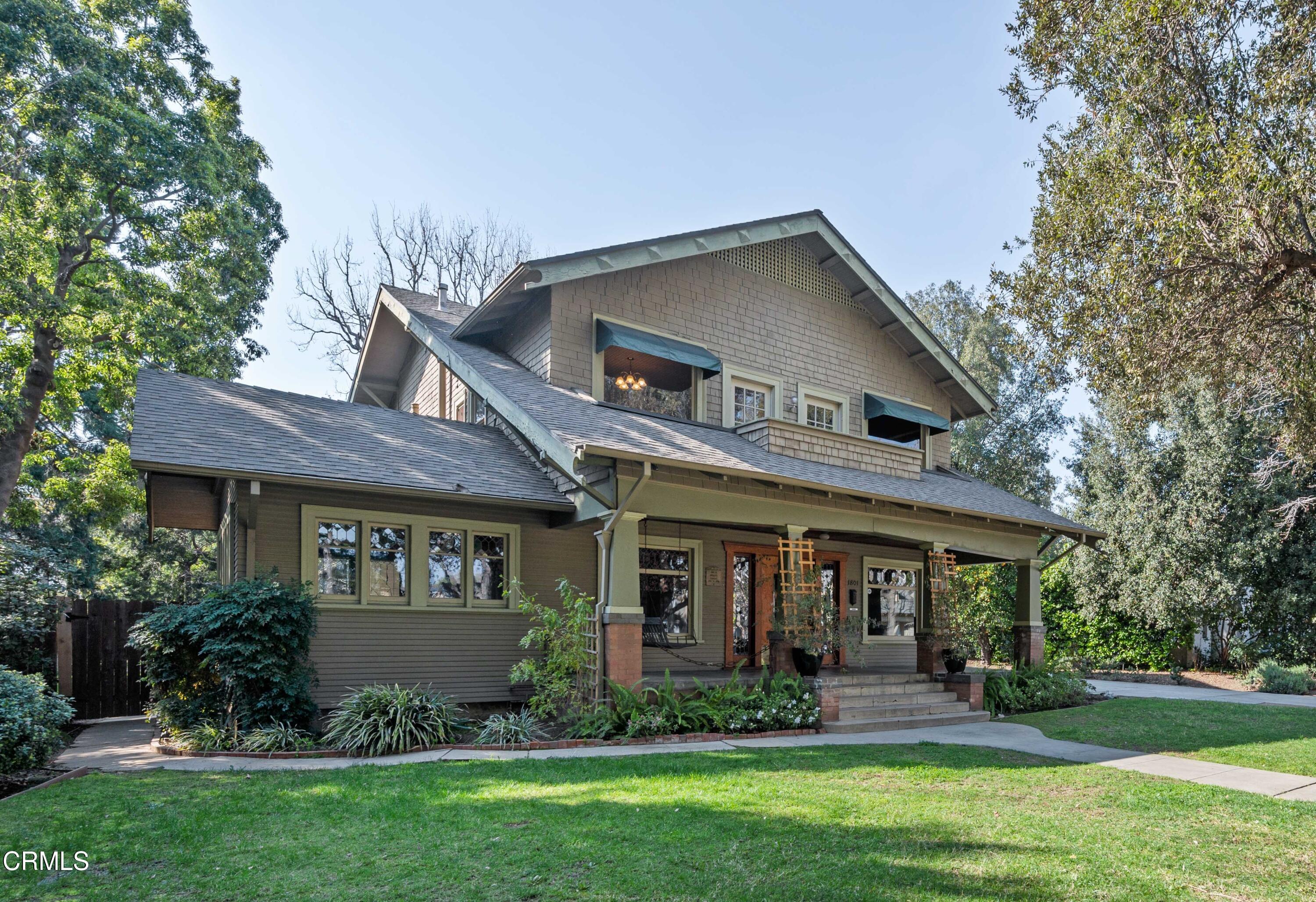 a front view of a house with a yard and porch