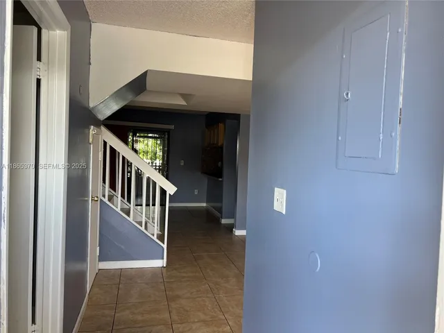 a view of an entryway door with a hallway