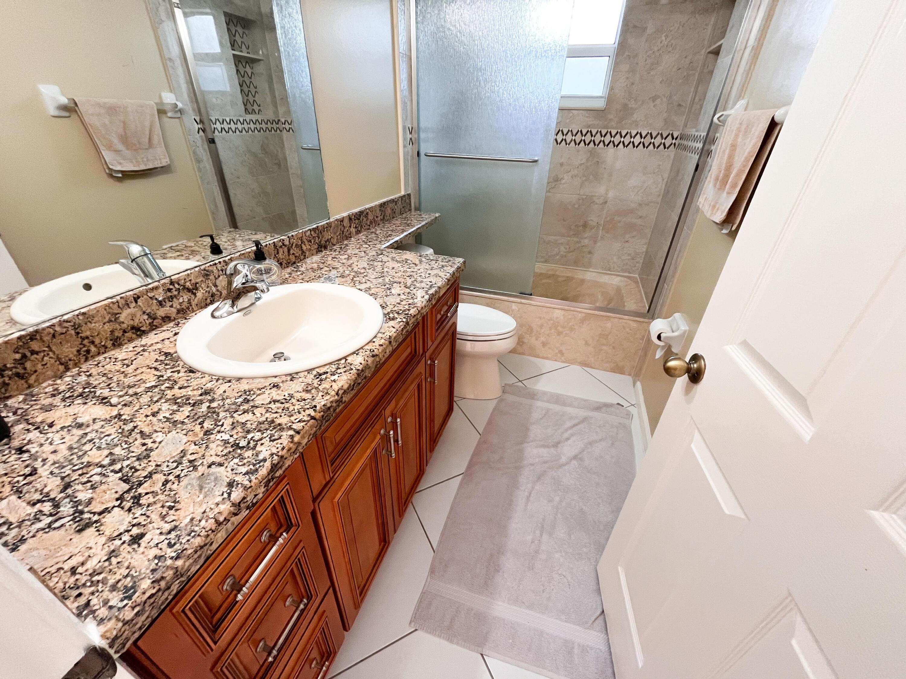 1305 Monteray Way Greenacres, FL 33413 - Photo 12 of 29 a bathroom with a sink and a mirror