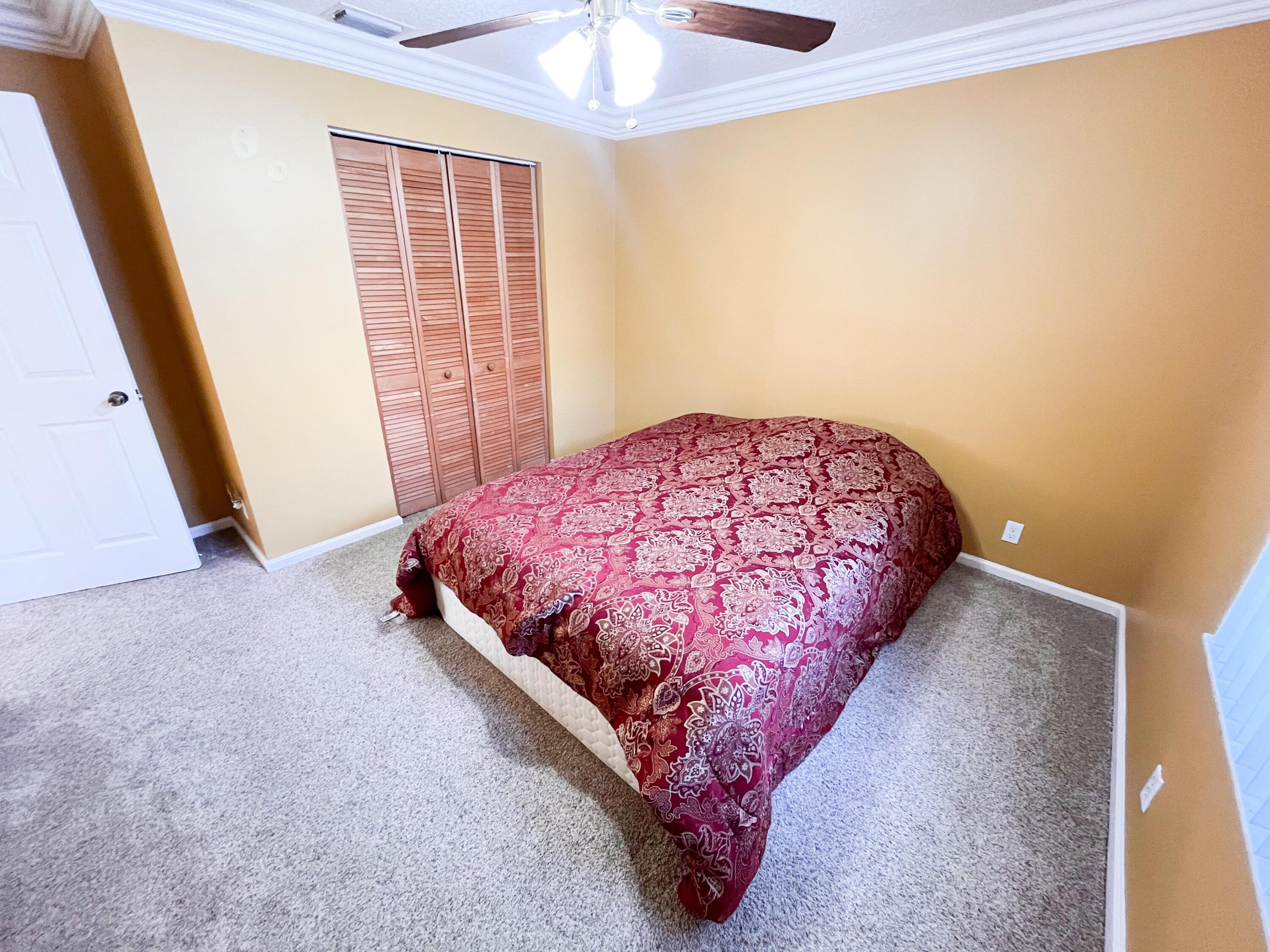 1305 Monteray Way Greenacres, FL 33413 - Photo 14 of 29 a bed sitting in a room next to a window