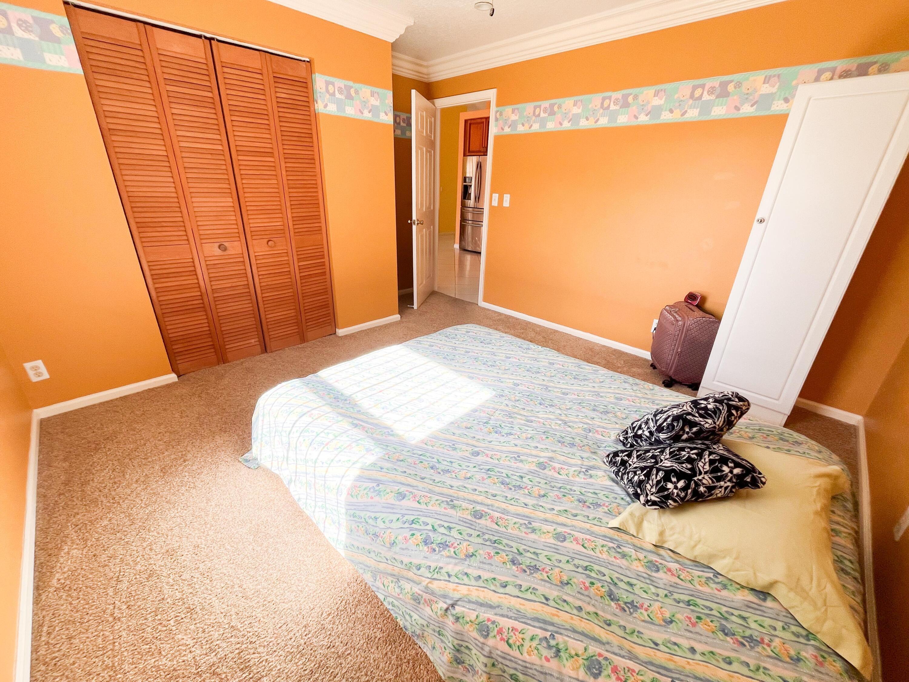 1305 Monteray Way Greenacres, FL 33413 - Photo 16 of 29 a bedroom with a bed and a window