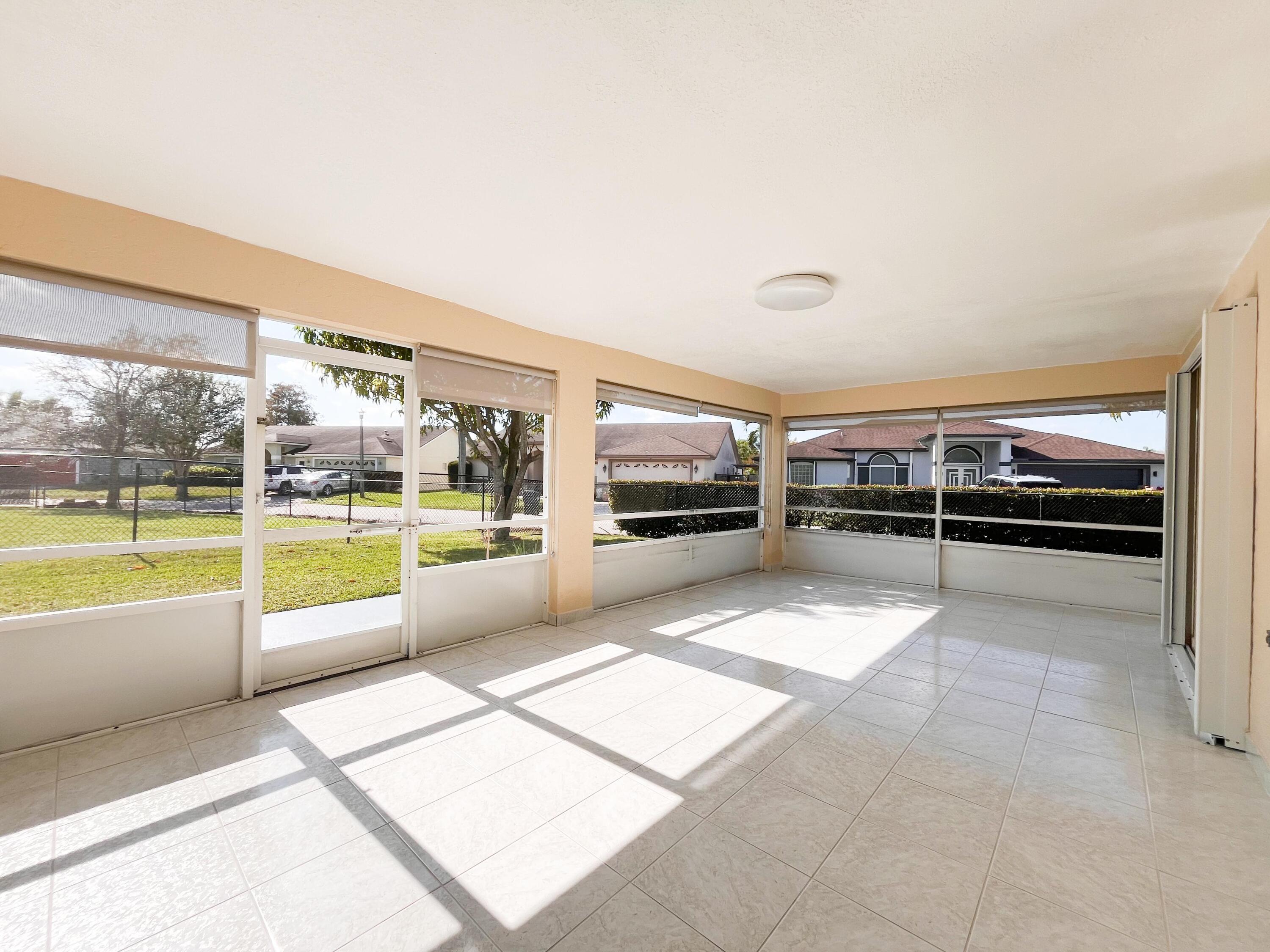 1305 Monteray Way Greenacres, FL 33413 - Photo 25 of 29 a view of a living room and kitchen with furniture