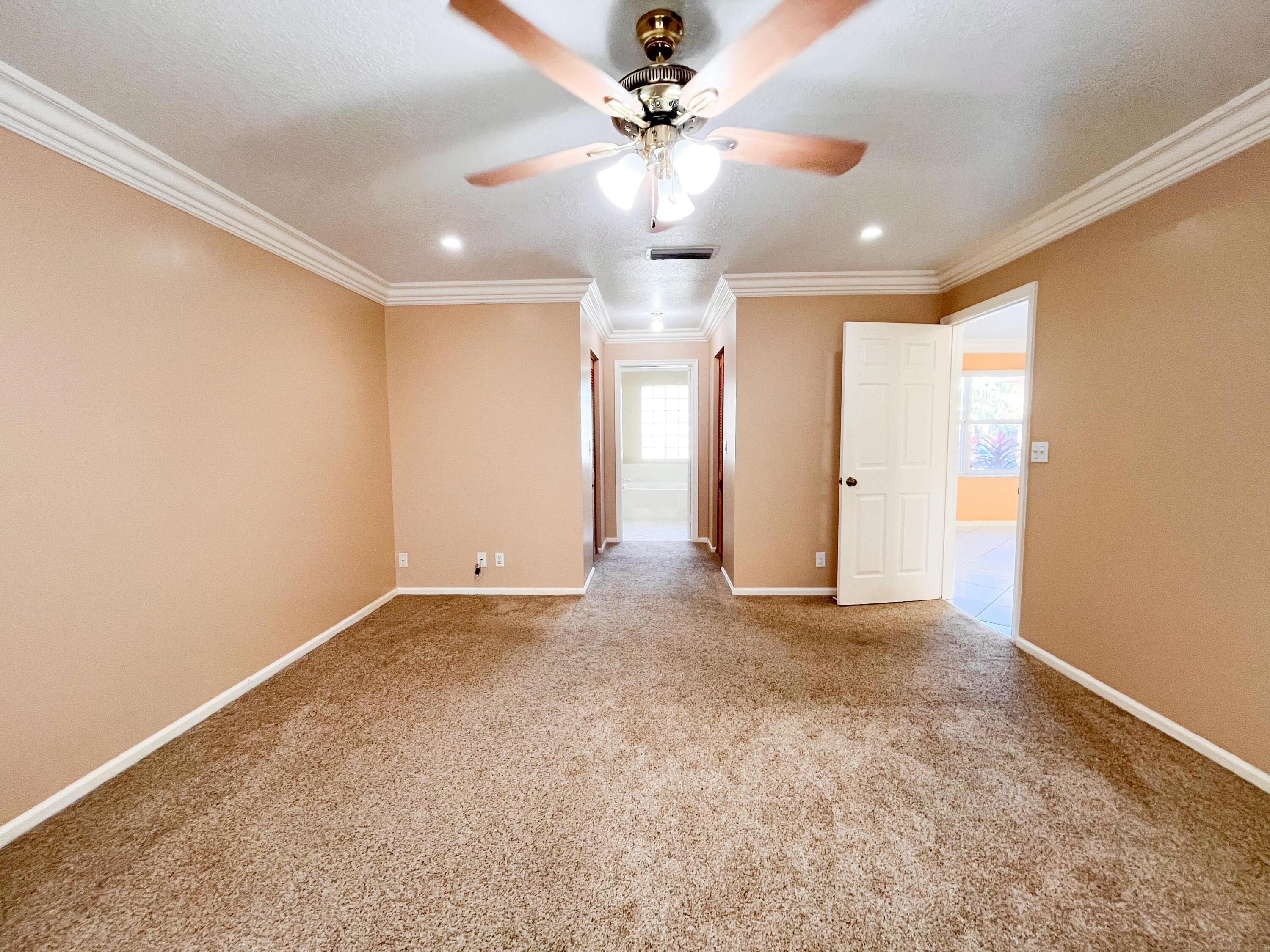1305 Monteray Way Greenacres, FL 33413 - Photo 6 of 29 an empty room with windows and fan