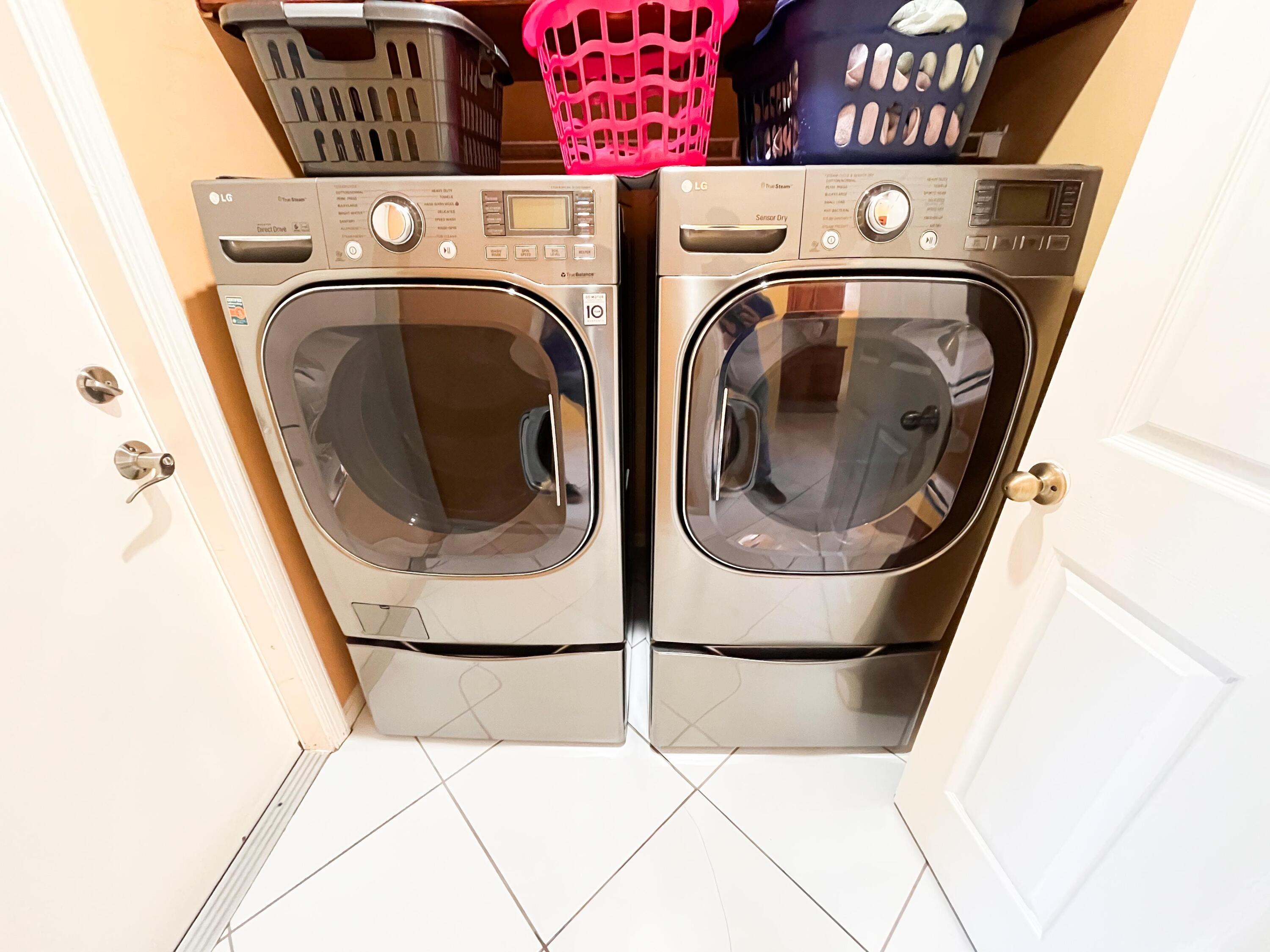 1305 Monteray Way Greenacres, FL 33413 - Photo 9 of 29 a utility room with dryer and washer