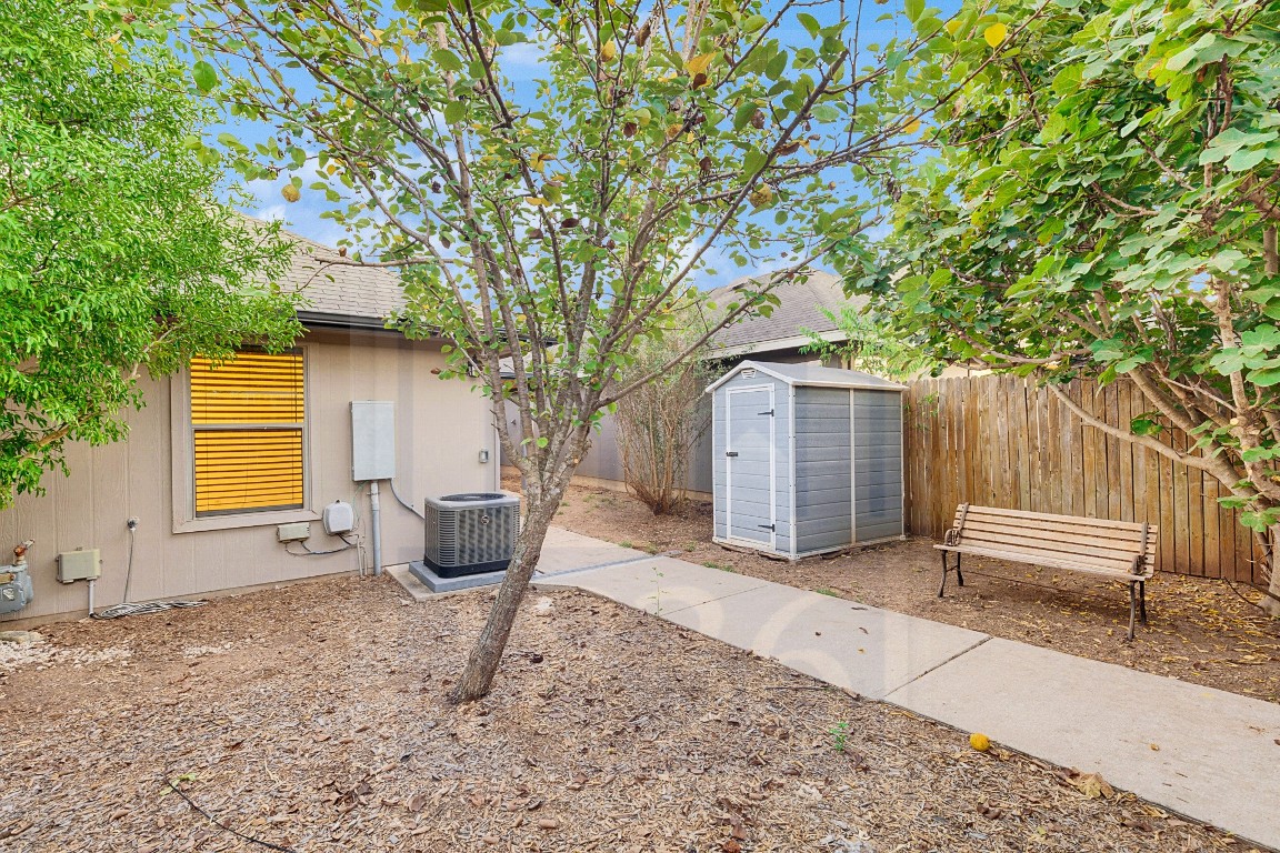 4622 Credo Lane, Unit 167 Austin, TX 78725 - Photo 20 of 25 a backyard of a house with table and chairs