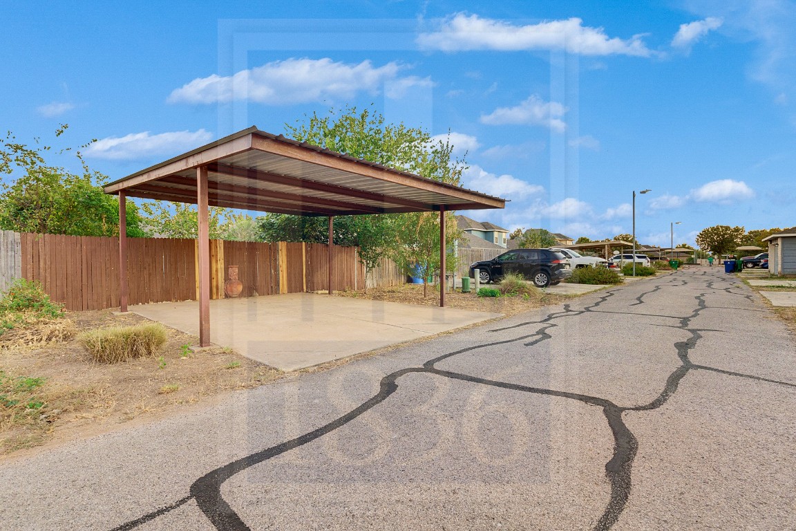 4622 Credo Lane, Unit 167 Austin, TX 78725 - Photo 24 of 25 a patio with a table and chairs under an umbrella