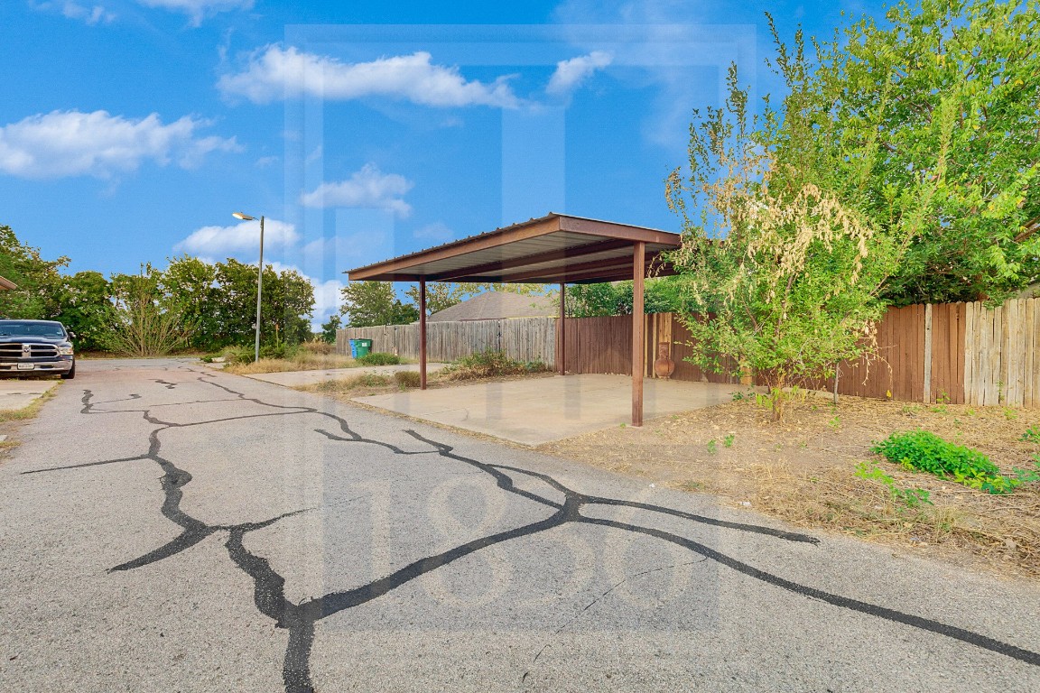 4622 Credo Lane, Unit 167 Austin, TX 78725 - Photo 25 of 25 a backyard of a house with table and chairs under an umbrella