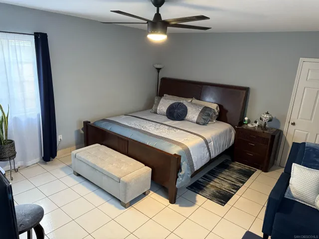 a bedroom with a bed lamp and a dresser