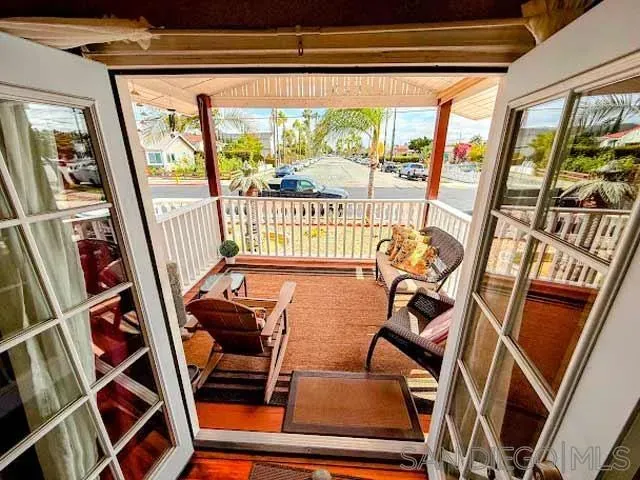 a view of a room with furniture and wooden floor