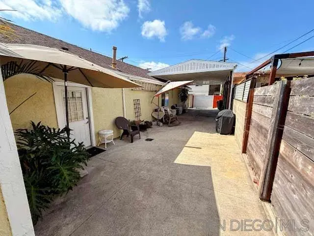 a view of a porch with furniture and garden