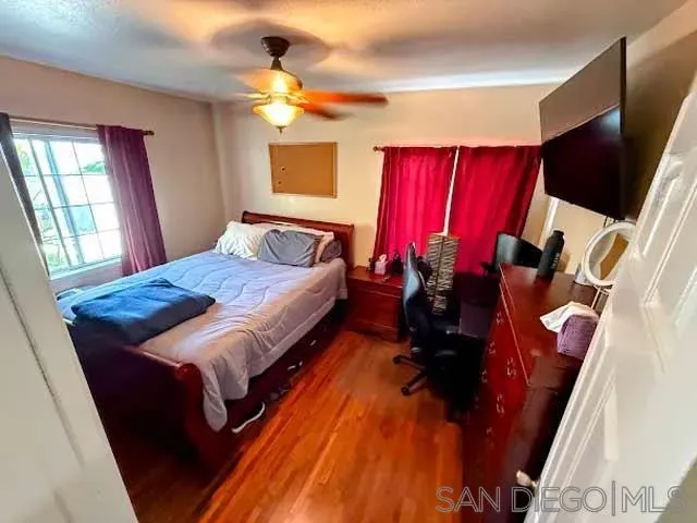 a bed room with a bed tv and a window