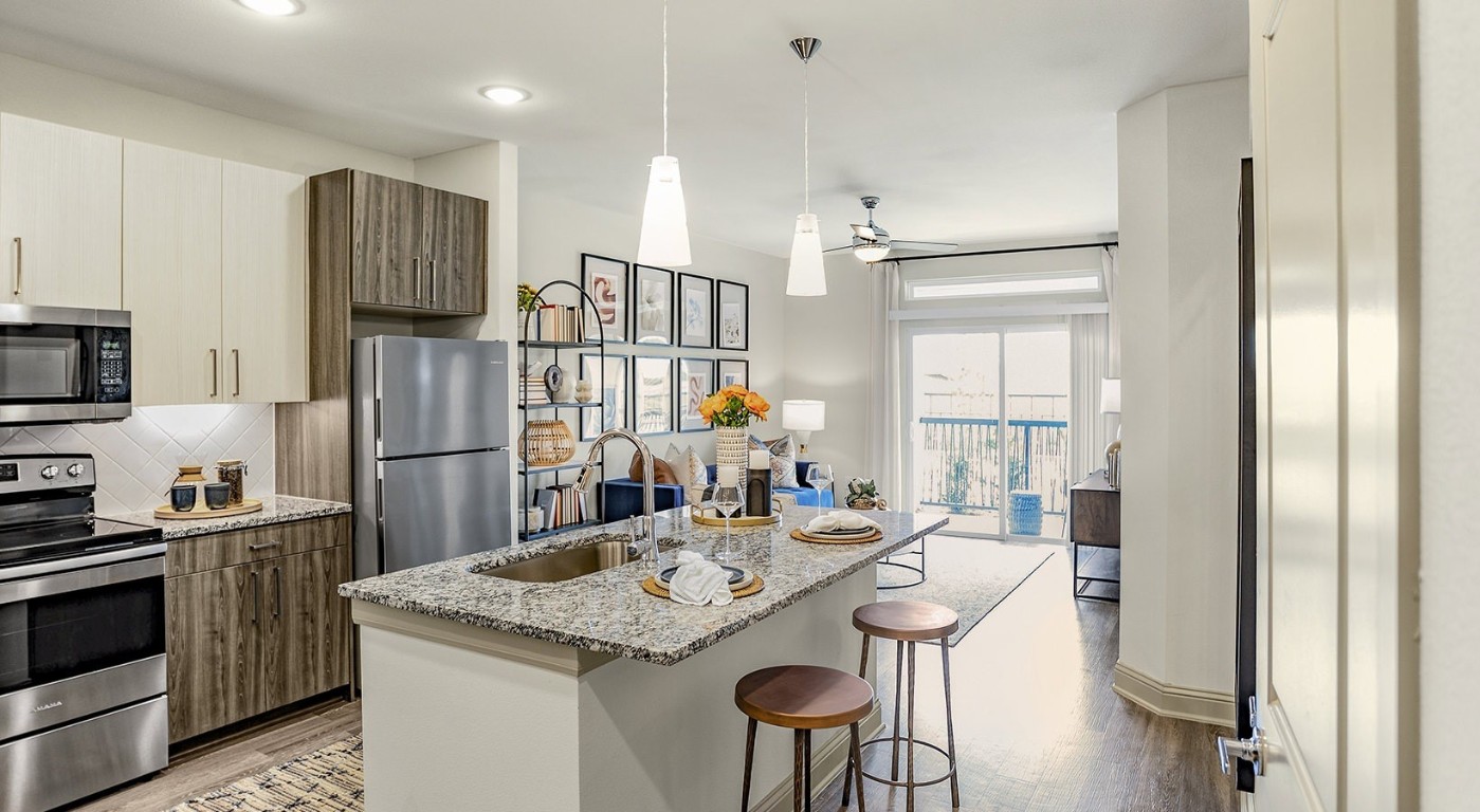7100 Uvalde Road, Unit 4306 Houston, TX 77049 - Photo 5 of 28 a kitchen with stainless steel appliances granite countertop a sink refrigerator and microwave