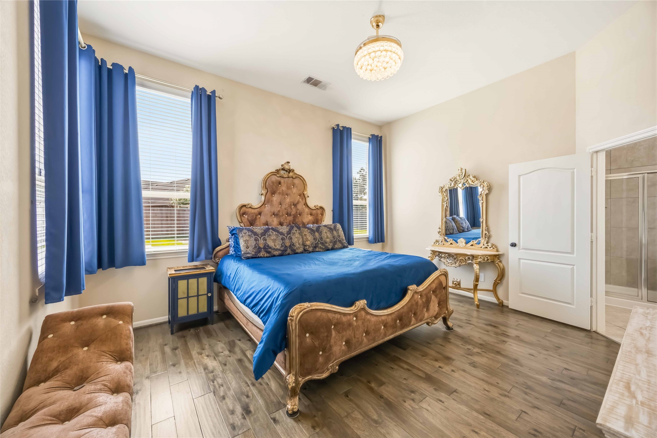 17206 Upper Ridge Lane Humble, TX 77346 - Photo 12 of 33 Primary Bedroom – Engineered wood flooring, large windows, and elegant finishes, offering a spacious retreat.