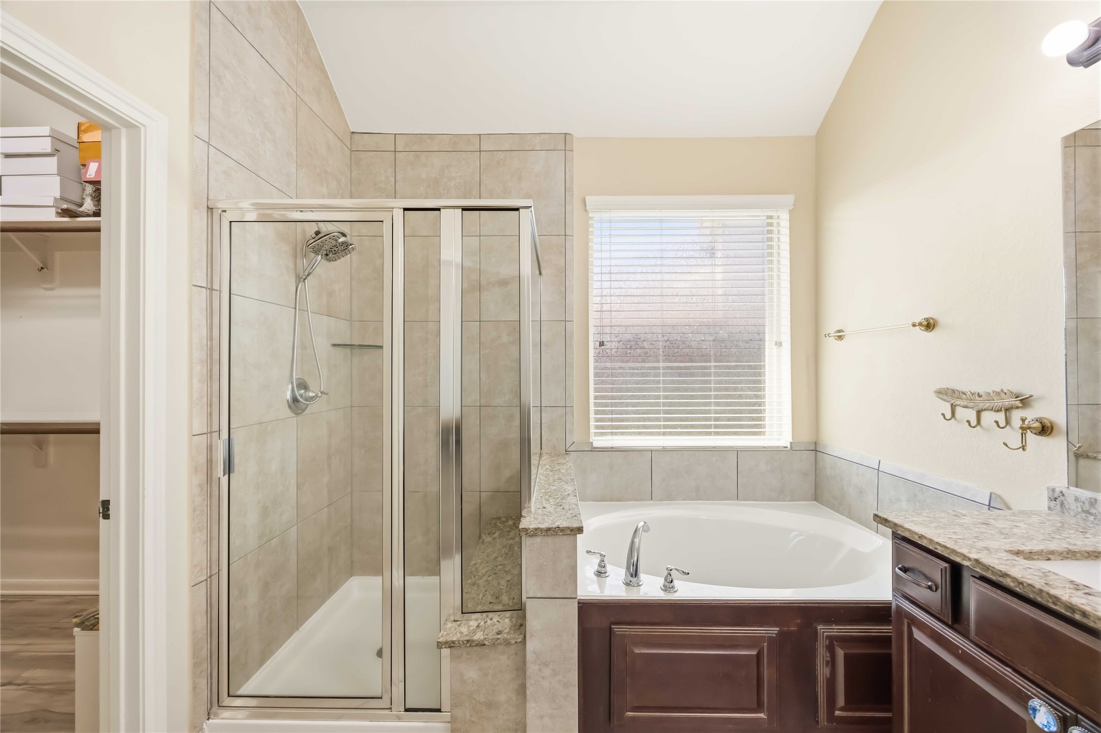 17206 Upper Ridge Lane Humble, TX 77346 - Photo 14 of 33 Primary Bathroom – Spa-inspired bathroom featuring dual vanities with granite counters, a soaking tub, and a separate glass-enclosed shower.