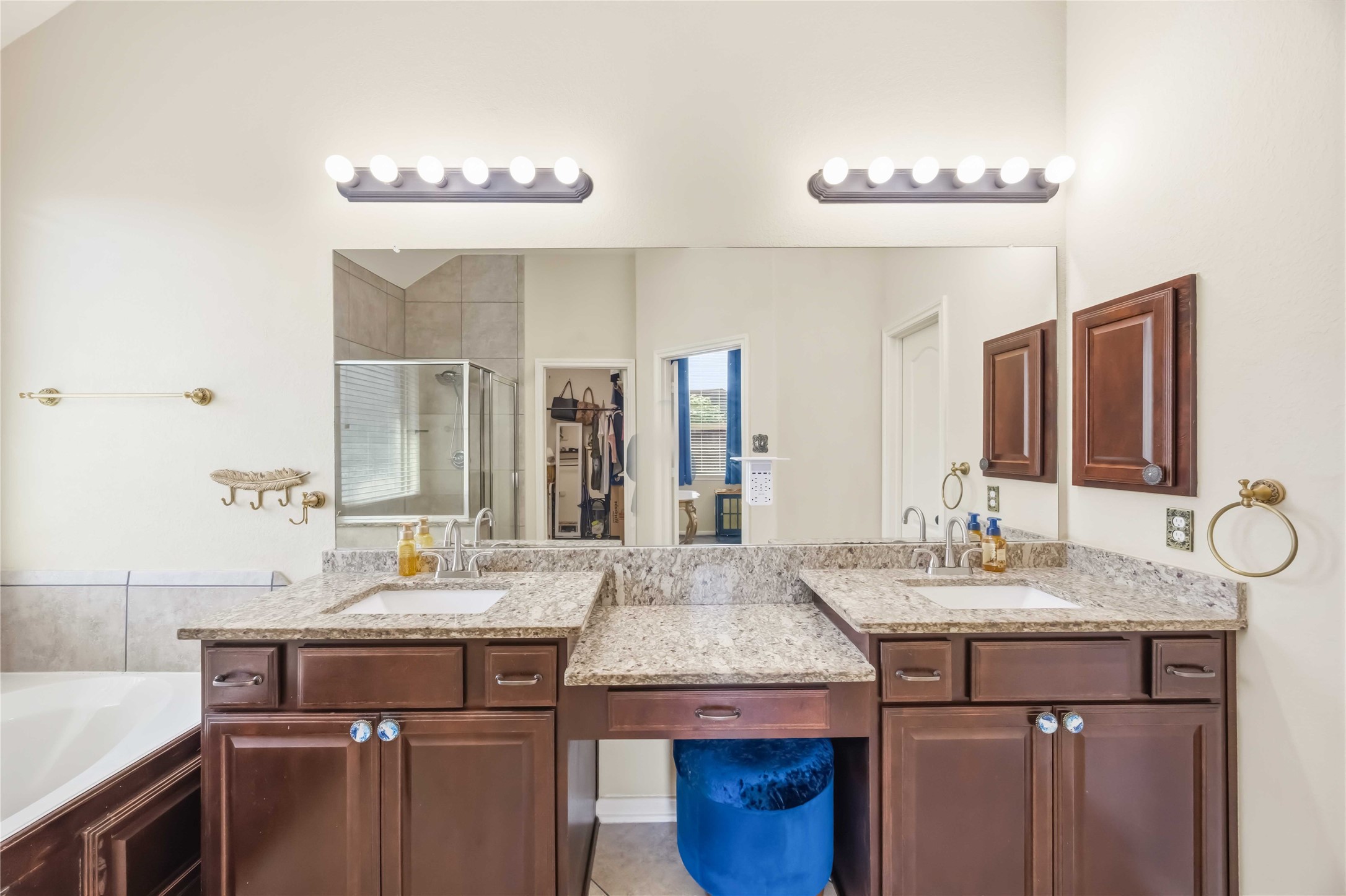 17206 Upper Ridge Lane Humble, TX 77346 - Photo 15 of 33 Primary Bathroom (Alternate View) – Spa-inspired bathroom featuring dual vanities with granite counters, a soaking tub, and a separate glass-enclosed shower.