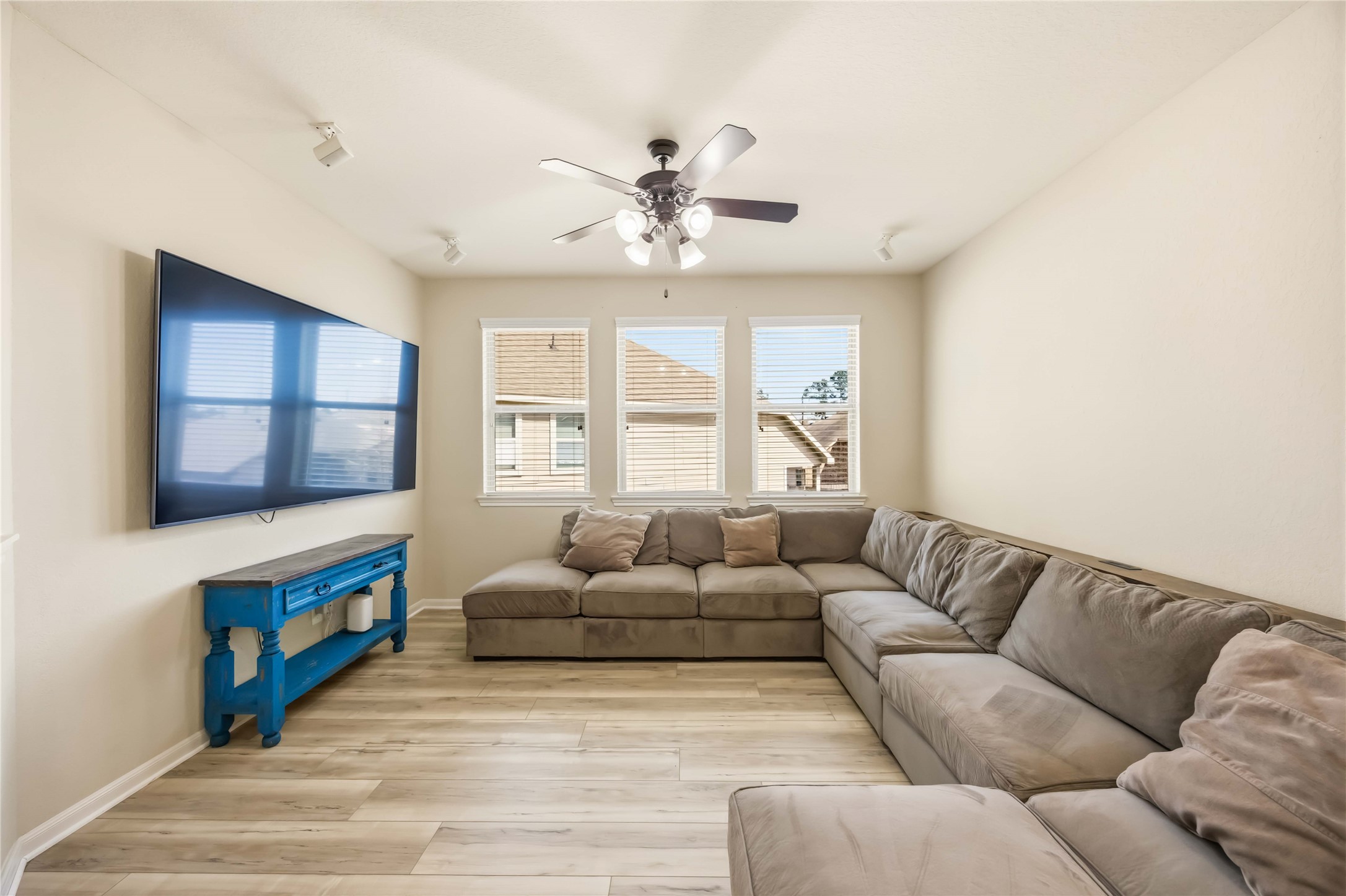 17206 Upper Ridge Lane Humble, TX 77346 - Photo 21 of 33 Game Room (Alternate View) – Generous layout with multiple windows providing natural light and ample space for sectional seating or entertainment use.