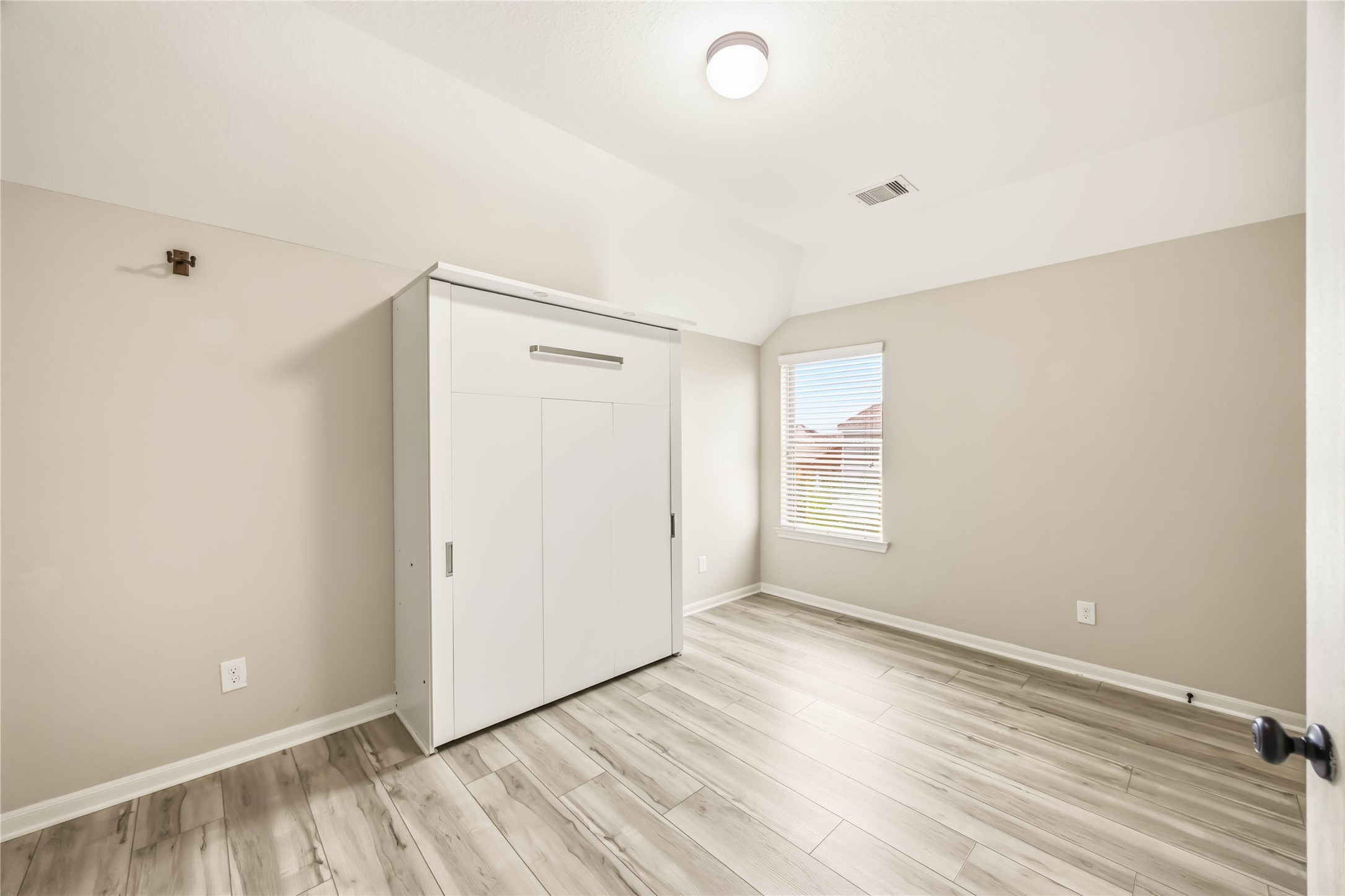 17206 Upper Ridge Lane Humble, TX 77346 - Photo 25 of 33 Guest Bedroom 3 – Oversized bedroom (15’2” x 10’6”) with walk-in closet and Murphy bed.