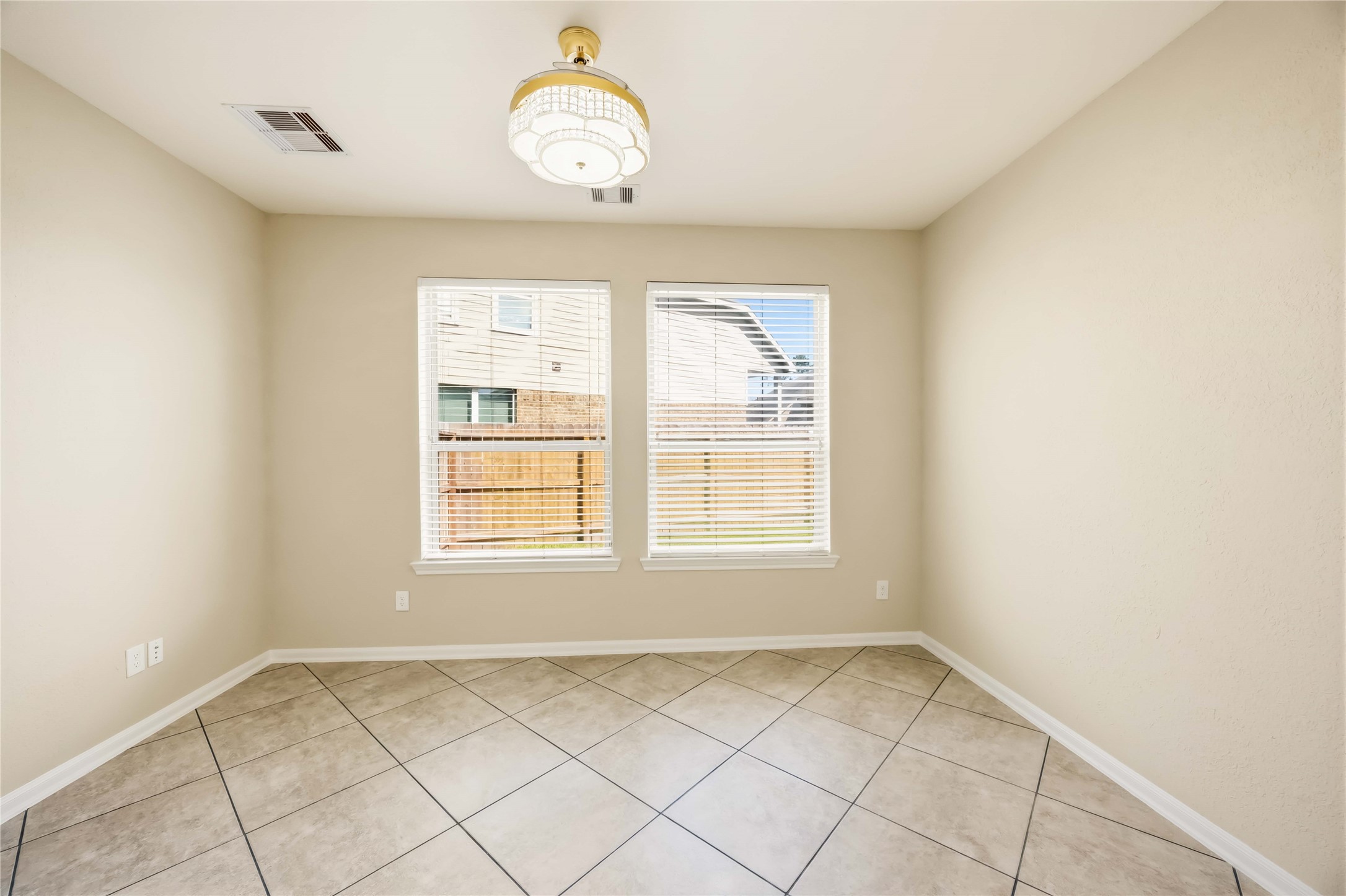 17206 Upper Ridge Lane Humble, TX 77346 - Photo 28 of 33 Study / Flex Room – Bright with tile flooring, statement light fixture, and large windows overlooking the backyard.