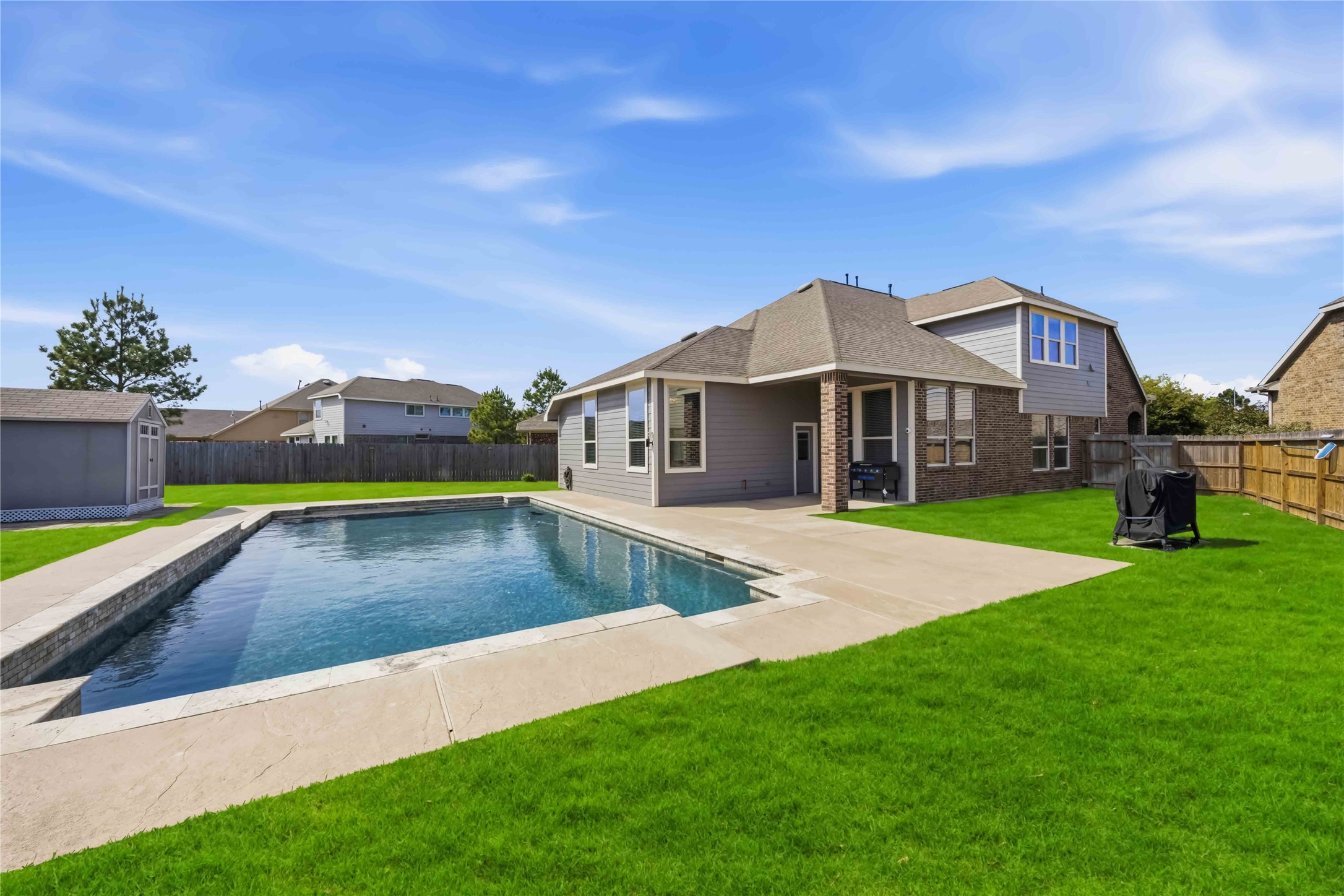 17206 Upper Ridge Lane Humble, TX 77346 - Photo 33 of 33 Backyard (Wide View) – Expansive yard with well-maintained lawn, salt water pool, and additional space for outdoor activities or gardening.