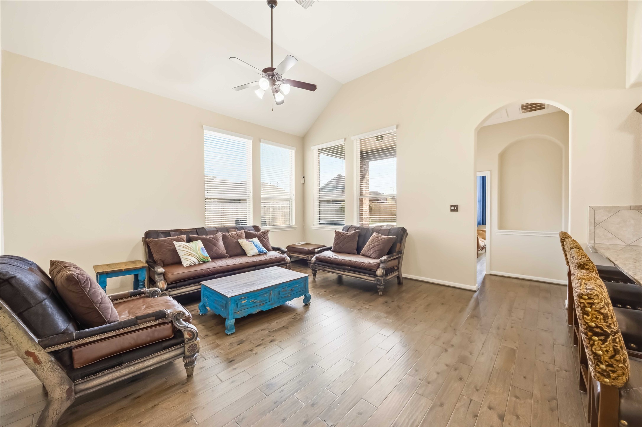 17206 Upper Ridge Lane Humble, TX 77346 - Photo 4 of 33 Living Room – Spacious living area featuring high ceilings, abundant natural light, and engineered wood flooring, ideal for relaxing or entertaining.