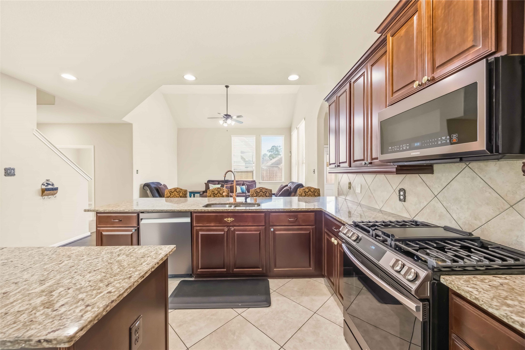 17206 Upper Ridge Lane Humble, TX 77346 - Photo 9 of 33 Kitchen (Alternate View) – Functional layout with center island, modern finishes, and clear sightlines to the living area for easy entertaining.