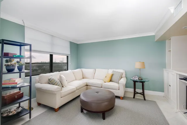 a living room with furniture and a lamp