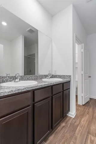 a bathroom with a granite countertop sink and a mirror