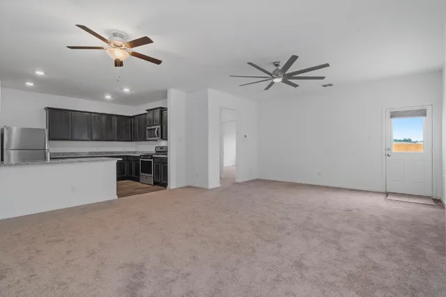 a view of a kitchen with a stove and a ceiling fan