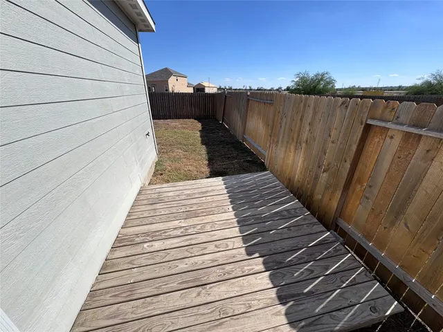 a view of balcony with wooden floor and fence