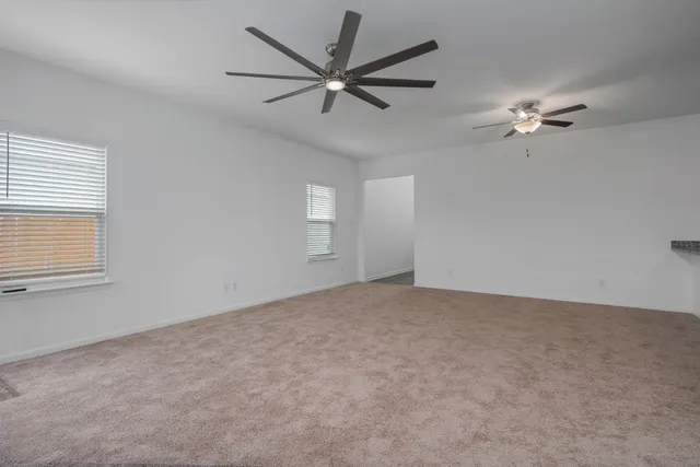 a view of a livingroom with a ceiling fan and a window
