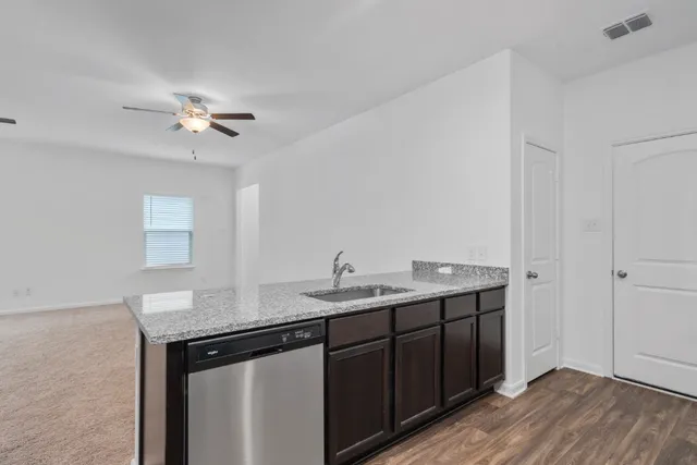 a kitchen with a sink and a refrigerator