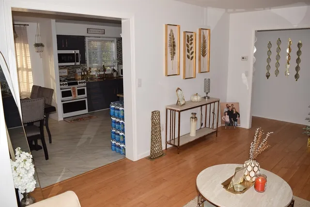 a bedroom with furniture and a wooden floor