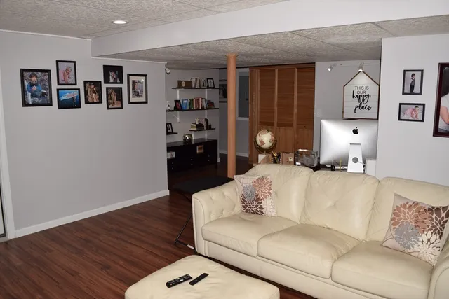 a living room with furniture and painting on the wall
