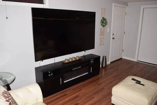 a living room with wooden floor and furniture