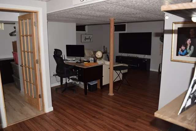a living room with furniture wooden floor and a flat screen tv