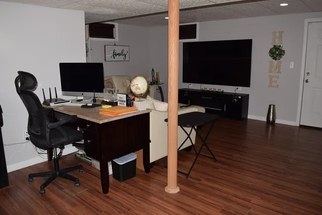 a kitchen with a breakfast area and a wooden floor