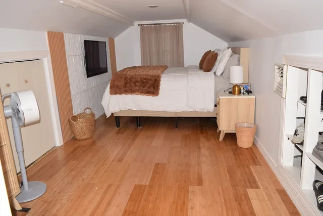 a bedroom with a bed and a white cabinet