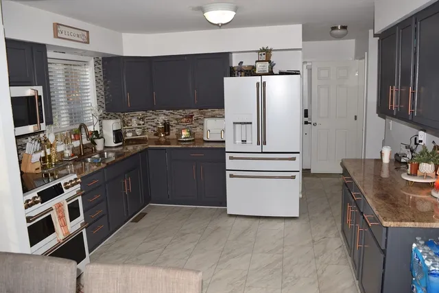 a kitchen with stainless steel appliances a refrigerator stove microwave and sink