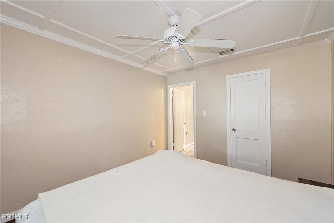 1905 Oakley Avenue, Unit A AND B Fort Myers, FL 33901 - Photo 12 of 30 a bedroom with a bed and a chandelier fan