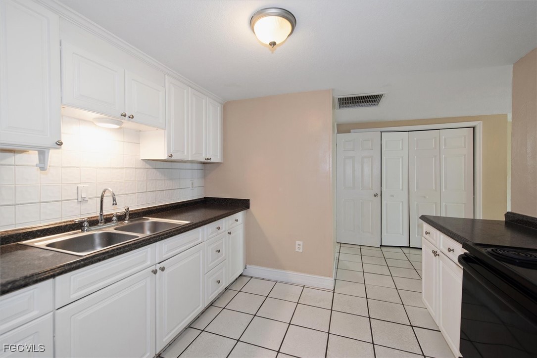 1905 Oakley Avenue, Unit A AND B Fort Myers, FL 33901 - Photo 19 of 30 a kitchen with a sink and cabinets